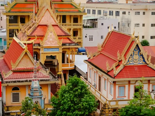 An aerial view of the Munir Khsay Pagoda, showing its intricate Khmer architecture in the middle of the city.