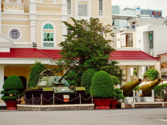 A war-era tank parked in front of the Military Zone 9 Museum, a poignant reminder of the past.