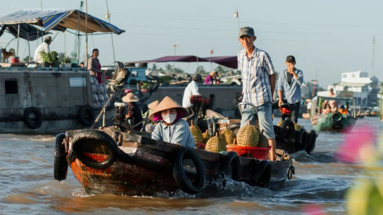 A Vietnamese boat filled with fresh pineapples and other tropical fruits for sale at Cai Rang floating market in Can Tho River Tour