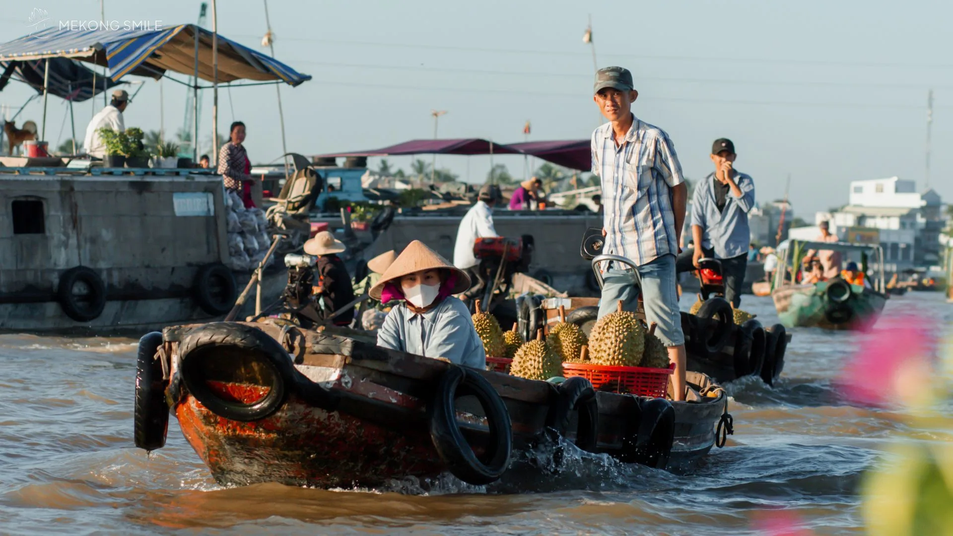 A Vietnamese boat filled with fresh pineapples and other tropical fruits for sale at Cai Rang floating market in Can Tho River Tour