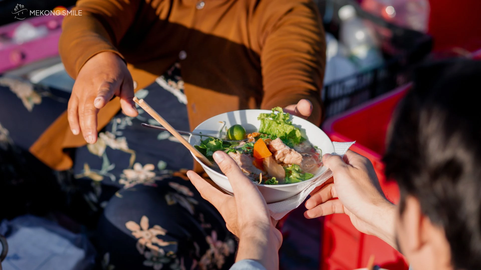 Tourists enjoying a traditional Vietnamese breakfast on a boat in Can Tho River Tour
