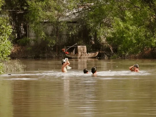 Local people engaged in daily activities like washing on the riverbanks in Can Tho, Mekong Delta