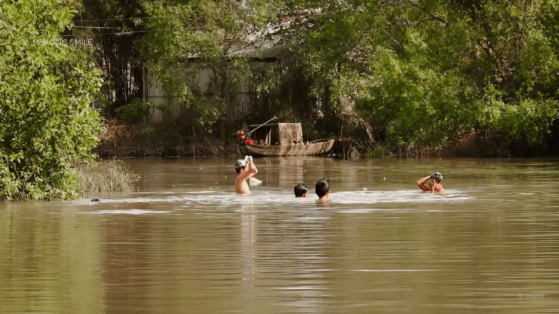 Local people engaged in daily activities like washing on the riverbanks in Can Tho, Mekong Delta