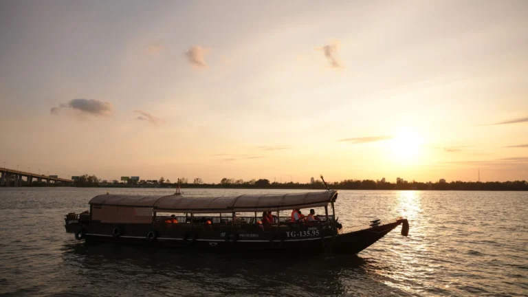 Cruise boat sailing under the golden sunset on the Hau River – Can Tho Sunset Tour with Mekong Smile