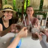 Tourists try to drink vietnamese coffee
