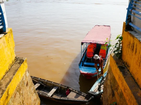 Traditional fish farming and wooden boats in Chau Doc Floating Village