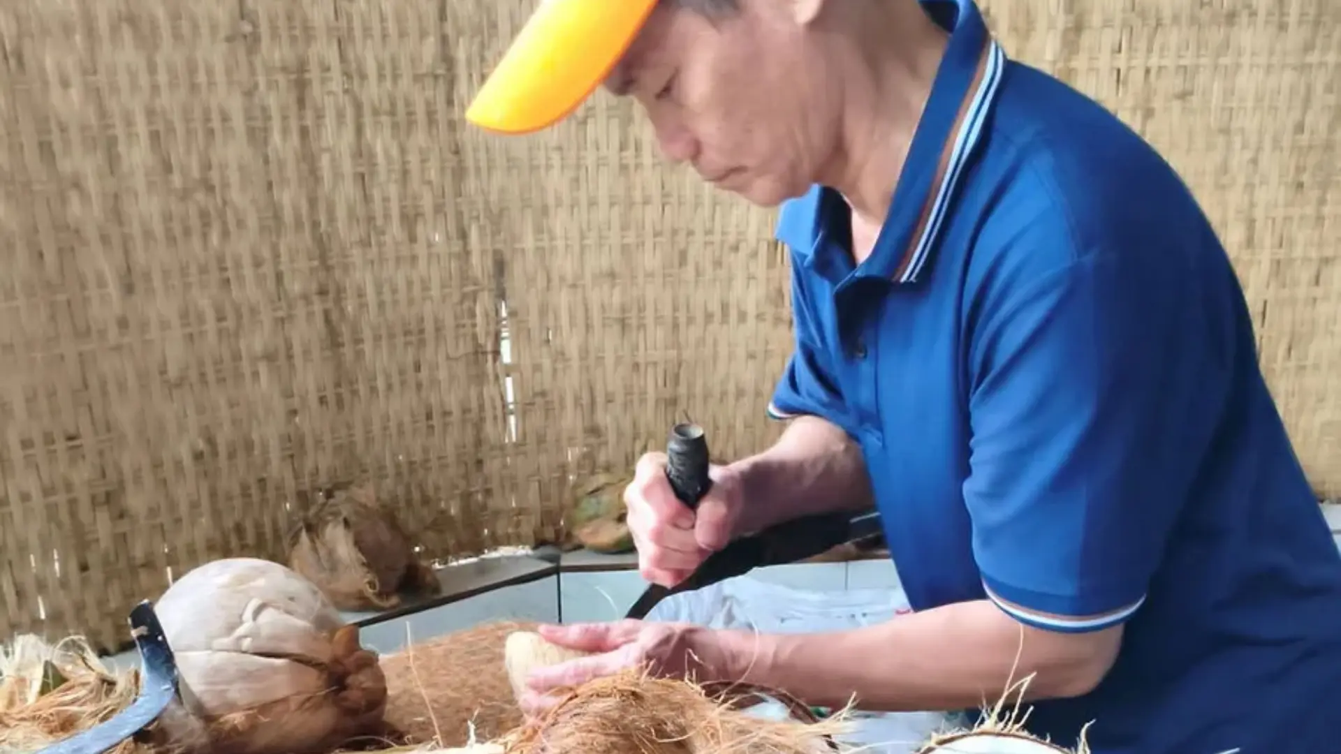 Coconut being grated at a local processing workshop in Ben Tre