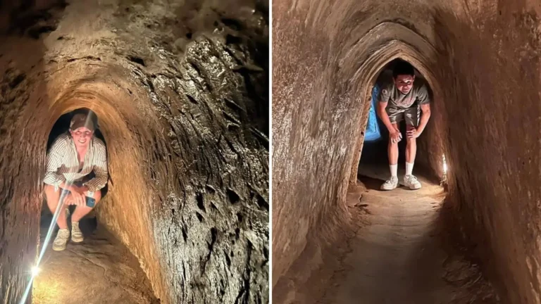 Visitors crouching and moving through narrow sections of the Cu Chi Tunnels