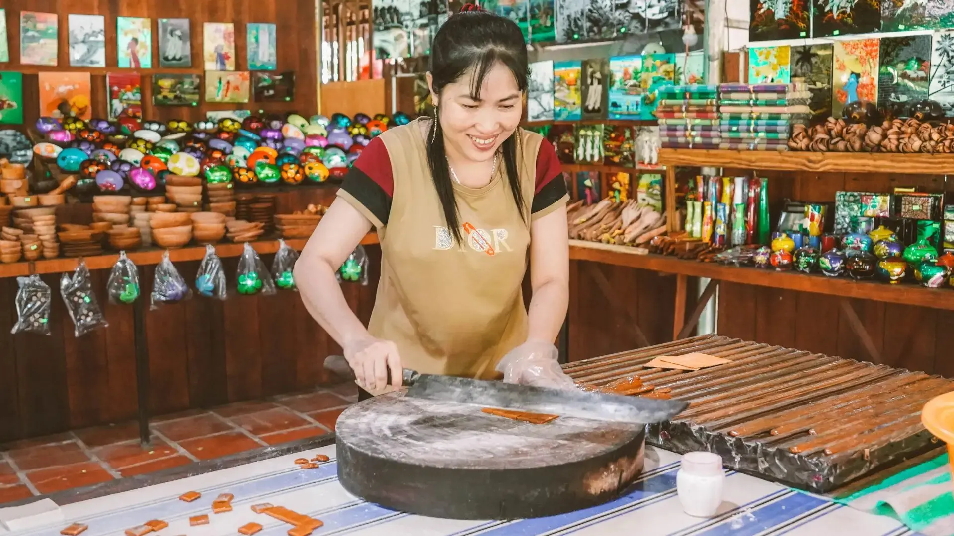 Local artisan cutting coconut candy at a workshop in Ben Tre