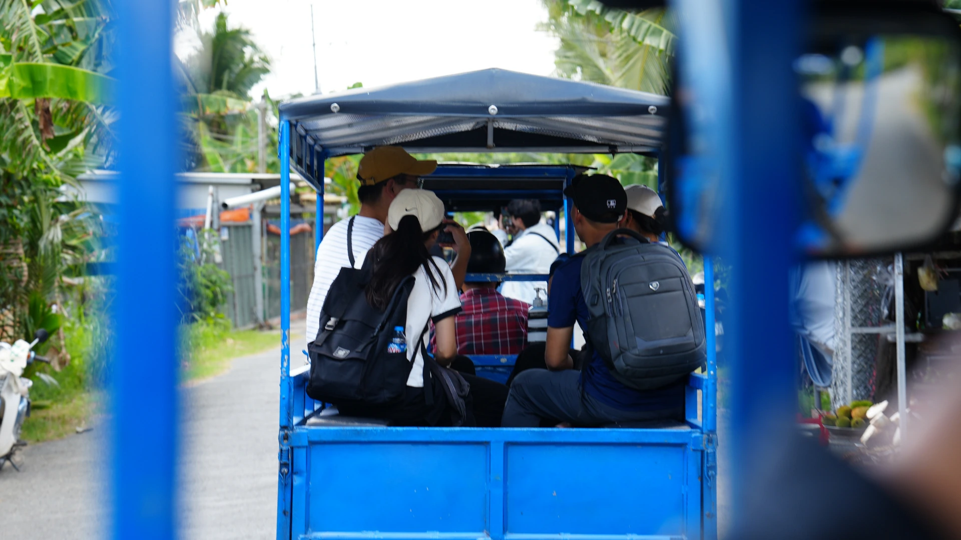 Electric car ride through peaceful village roads in the Mekong Delta countryside