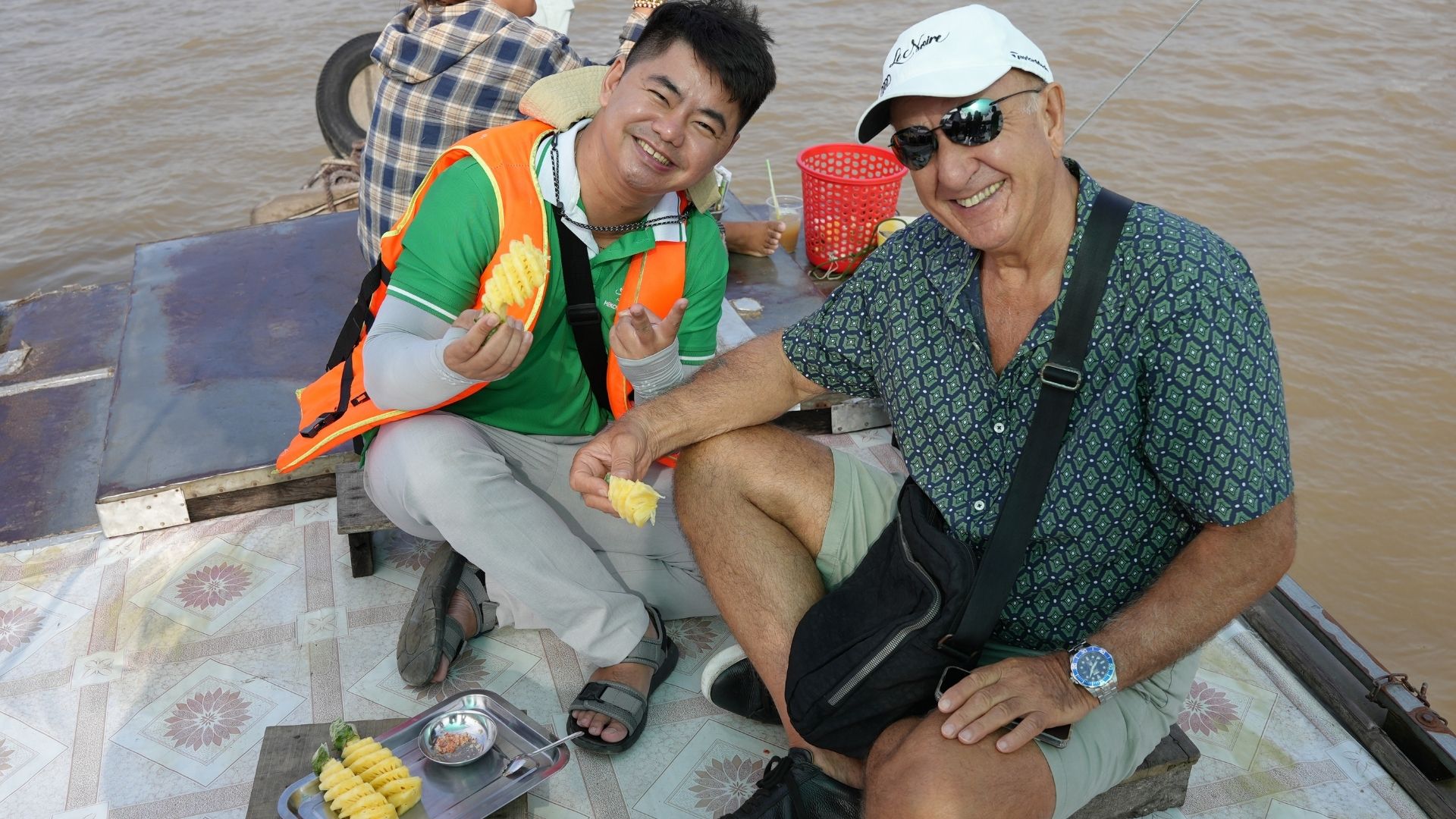 Traveler and local guide during a Mekong Delta boat tour in Vietnam