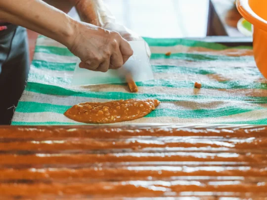 Observing traditional candy-making and tasting freshly cooked coconut candy in My Tho