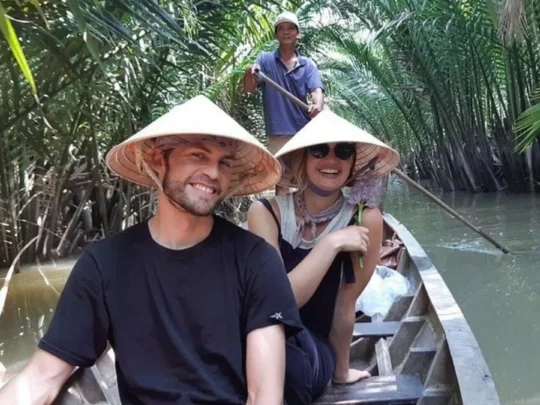 Guests enjoying a sampan ride through a canal in Ben Tre