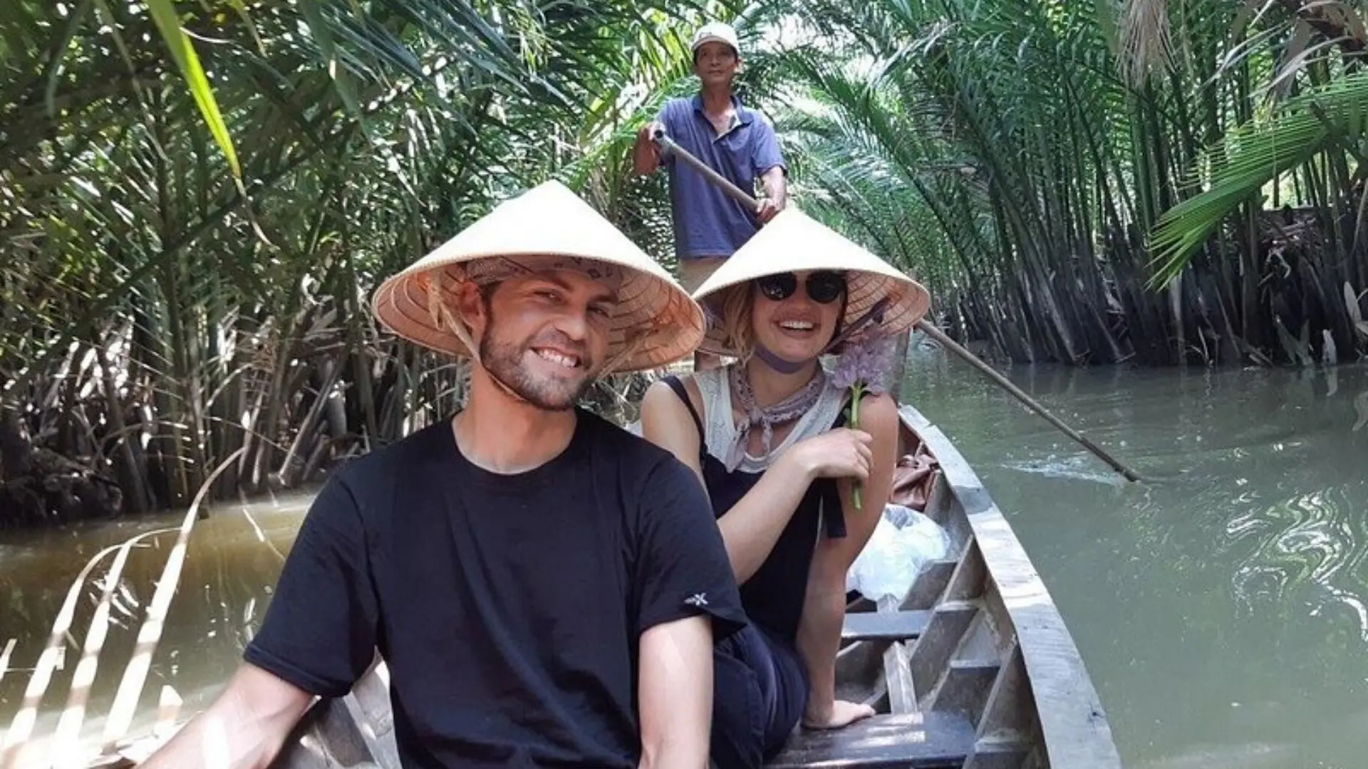 Guests enjoying a sampan ride through a canal in Ben Tre