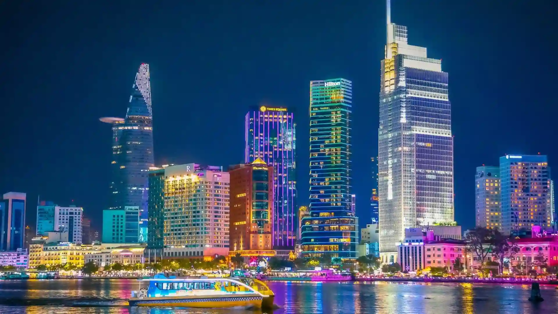 Vietnam Travel Guide for First-Time Visitors 22 Illuminated skyscrapers and waterfront buildings in Ho Chi Minh City at night