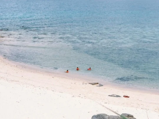 Sandy beach and clear blue water on Hon Tai Island in Con Dao