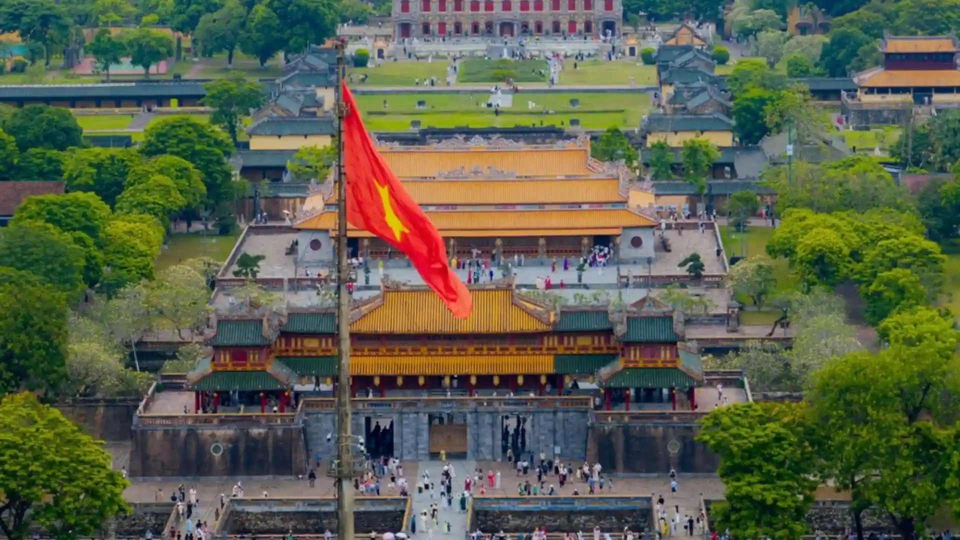 Vietnam Travel Guide for First-Time Visitors 19 Vietnamese national flag flying above historic buildings at the Imperial City in Hue