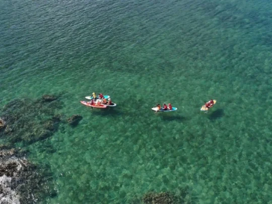 Kayaking and snorkeling activities in clear water during the Bamboo Lagoon Con Dao tour