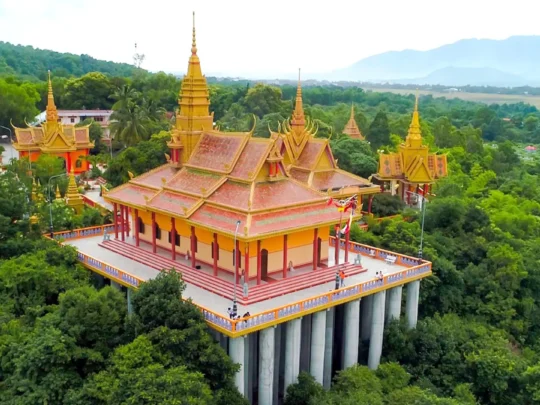 Khmer Pagoda in Chau Doc with golden spires and Buddhist monks