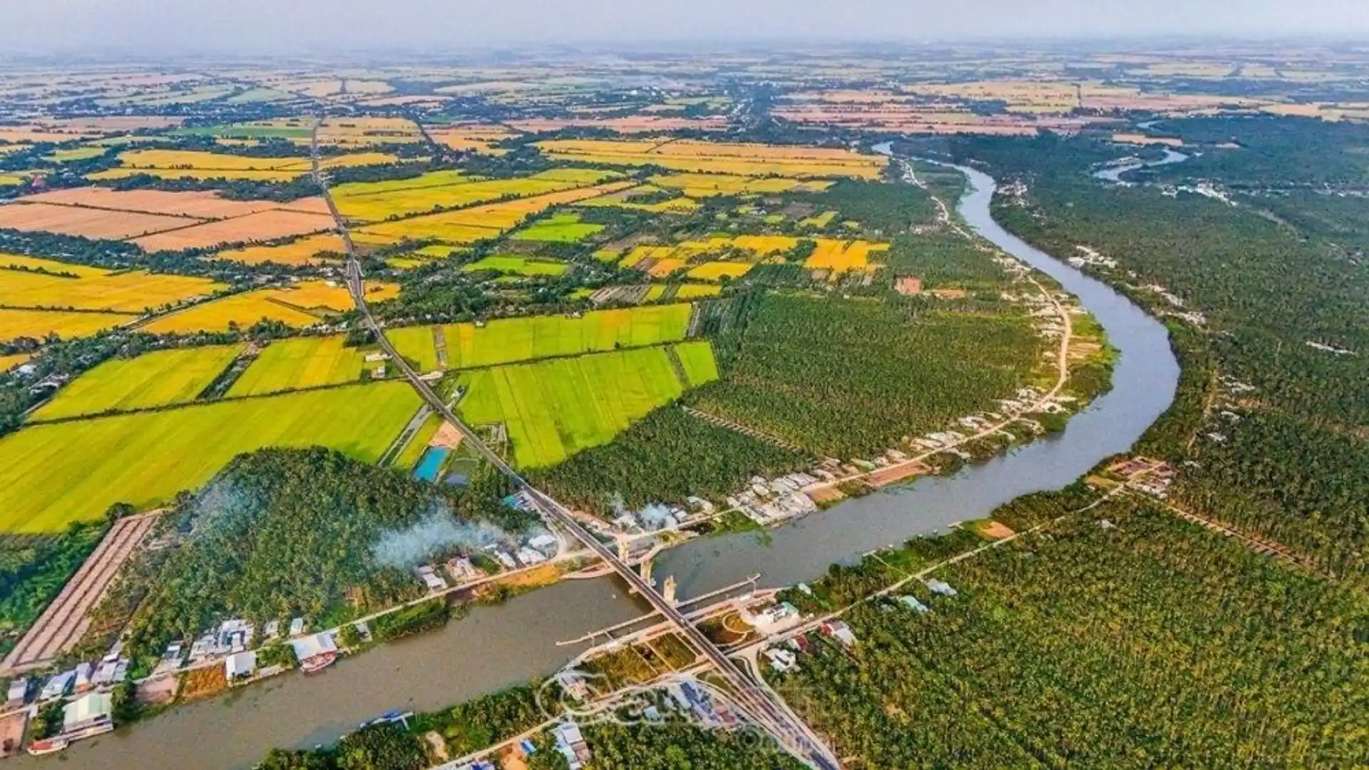Mekong Delta Travel Guide: Where to Go and How to Plan Your Trip 9 Aerial view of a Mekong Delta river winding through farmland and settlements