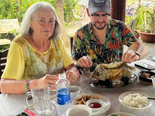 Tourists eating traditional Vietnamese lunch in An Binh Islet Tour