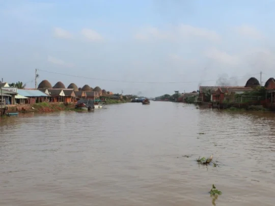 Red brick kilns and smoky chimneys at the An Binh Pottery Village