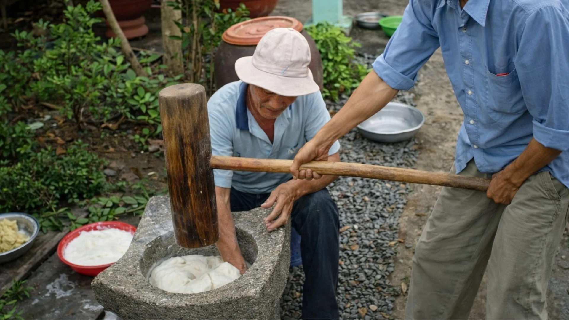 Son Doc Puff Rice Paper Village: Ben Tre’s Coconut Craft Heritage 157 Son Doc Puff Rice Paper Village artisan pounding sticky rice dough in a stone mortar
