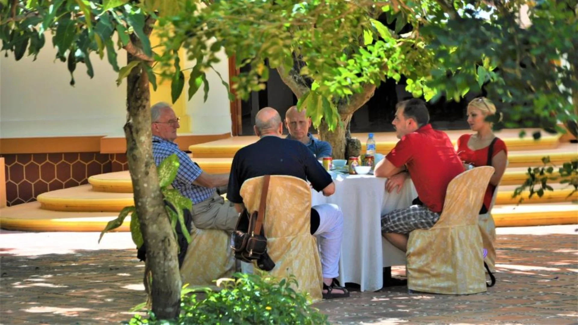 Mekong Smile Ba Duc Ancient House tourists enjoying traditional Mekong meal in ancient house garden