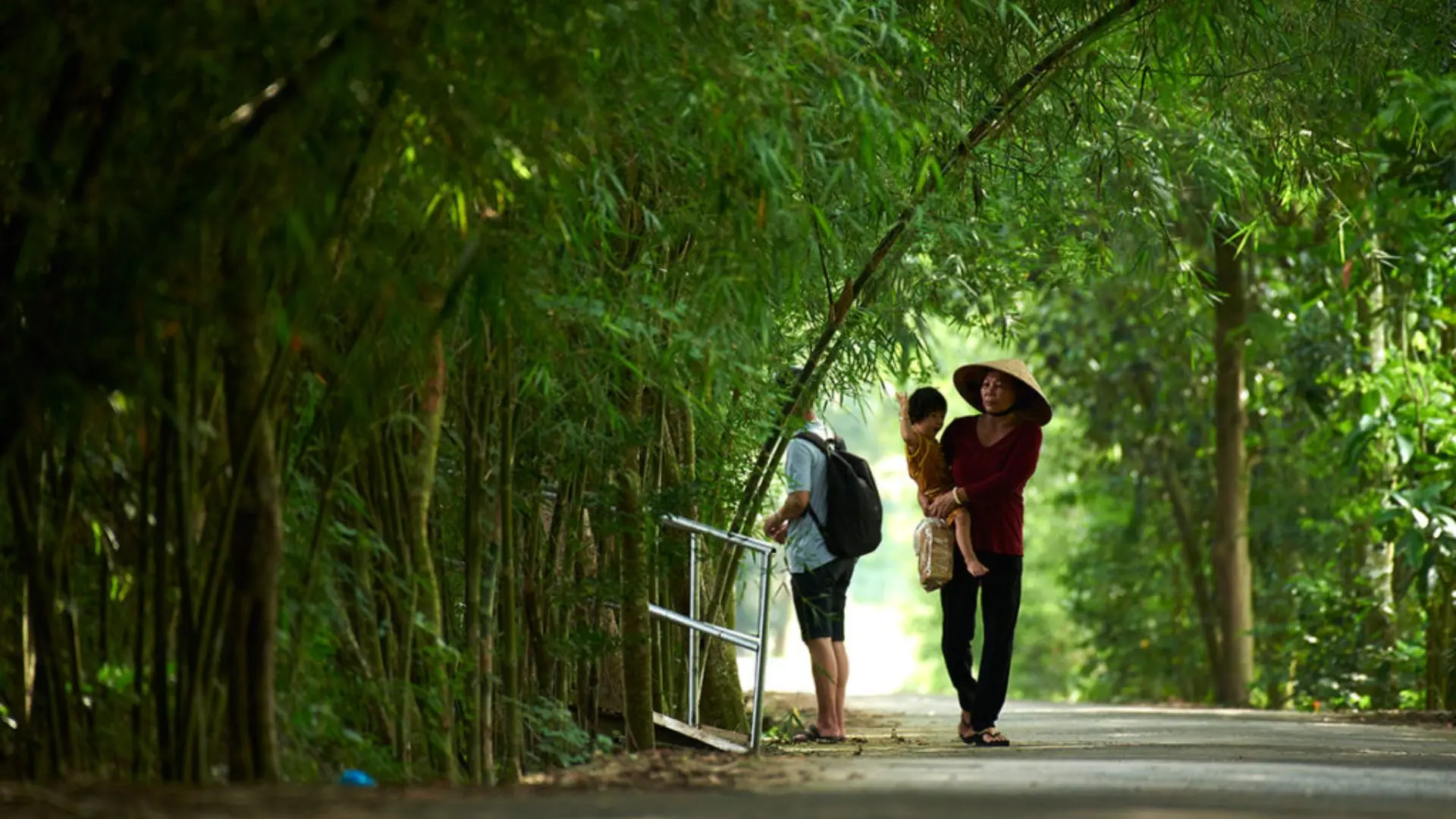 Bang Lang Stork Garden: Exploring Nature’s Symphony in Can Tho 283 Visitors walking along a bamboo-lined path at Bang Lang Stork Garden
