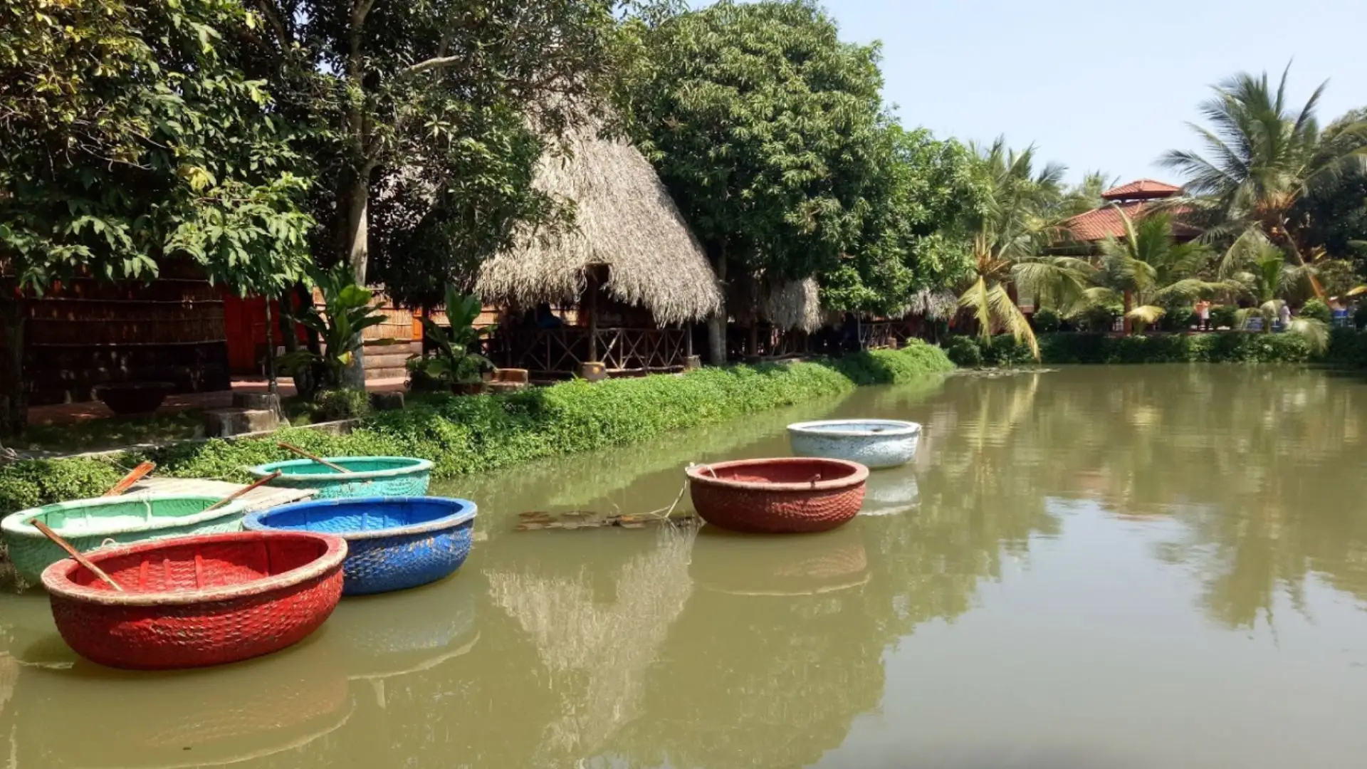 Traditional round boats on a canal at Bao Gia Trang Vien Ecological Village in Can Tho