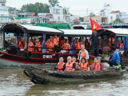 Mekong Smile Bassac Cruise Cai Be Can Tho excursion boat with tourists on Mekong River