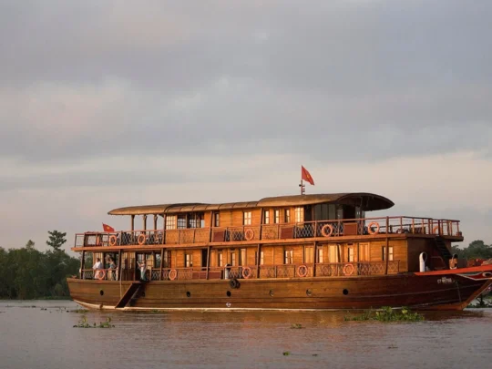 Mekong Smile Bassac Cruise Cai Be Can Tho traditional Mekong wooden cruise boat on the river
