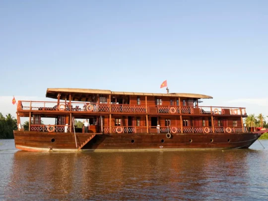 Mekong Smile Bassac Cruise Can Tho Bassac Cruise wooden ship side view on Mekong River