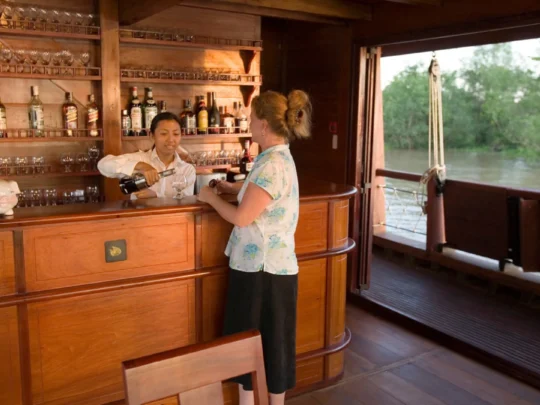 Mekong Smile Bassac Cruise Can Tho Cai Be Bassac Cruise bar area with bartender serving drinks