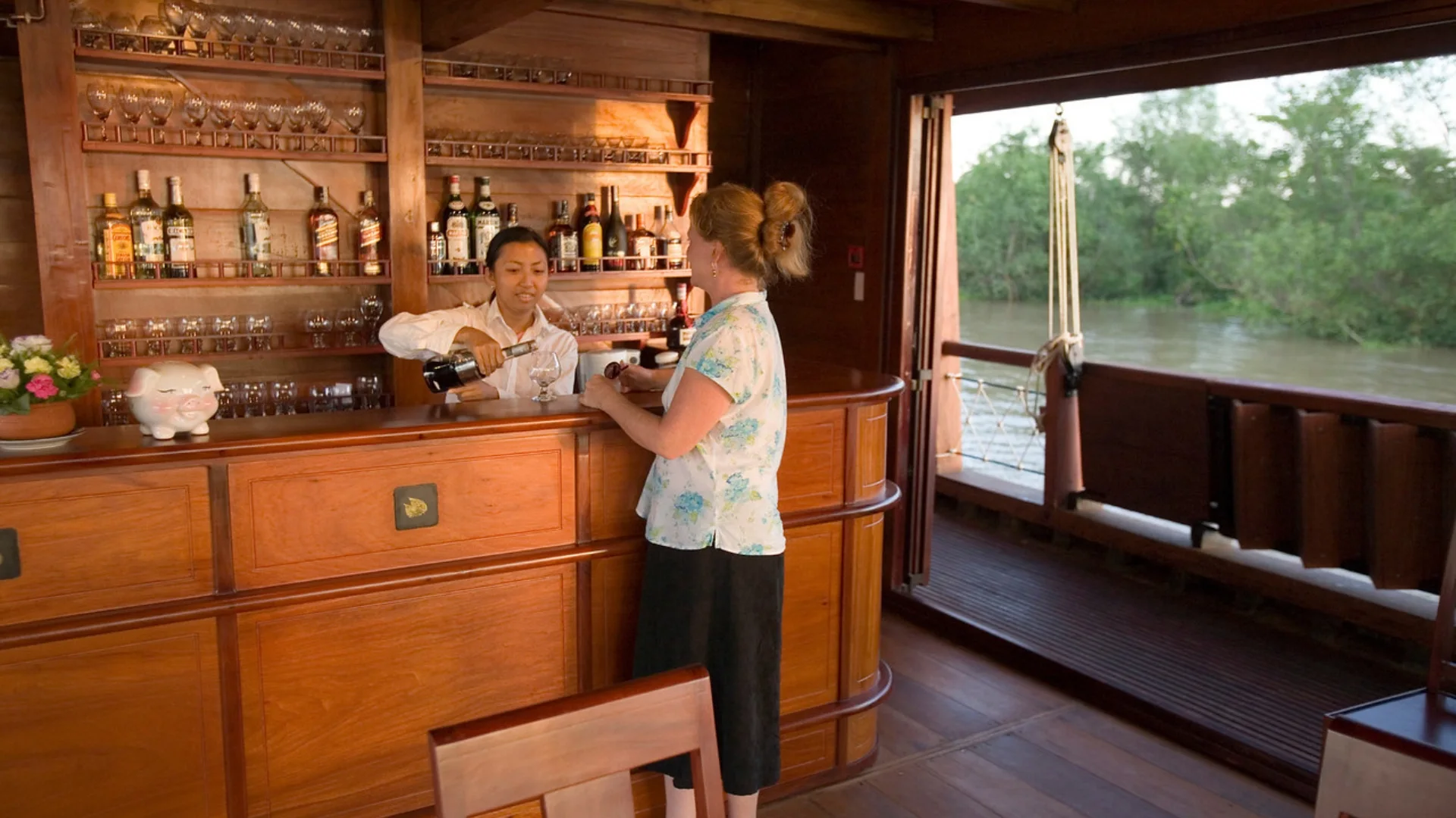 Mekong Smile Bassac Cruise Can Tho Cai Be Bassac Cruise bar area with bartender serving drinks