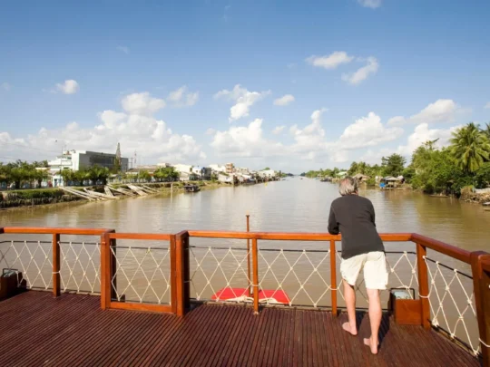 Mekong Smile Bassac Cruise Can Tho Cai Be tourist enjoying river view from Bassac Cruise deck