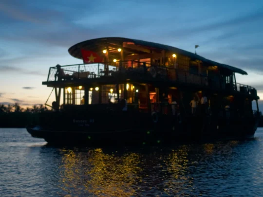 Mekong Smile Bassac Cruise Can Tho Cai Be Bassac Cruise illuminated at night on Mekong River