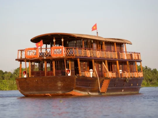 Mekong Smile Bassac Cruise Can Tho Cai Be traditional wooden Bassac Cruise sailing on Mekong River