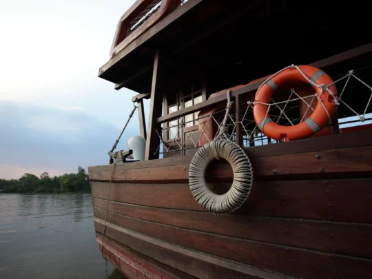 Mekong Smile Bassac Cruise Can Tho Cai Be Bassac Cruise ship side view sailing on Mekong River