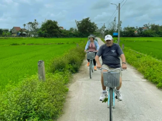 Mekong Smile Bassac Cruise Can Tho Cai Be tourists cycling through Mekong Delta countryside village