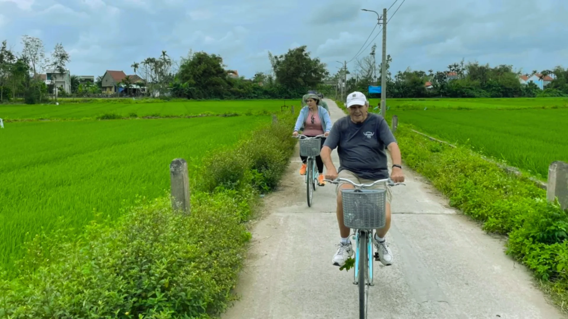Mekong Smile Bassac Cruise Can Tho Cai Be tourists cycling through Mekong Delta countryside village