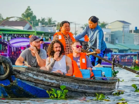 Mekong Smile Bassac Cruise Can Tho tourists enjoying local boat experience on Mekong River