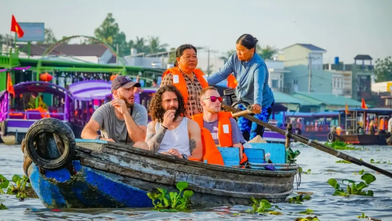 Mekong Smile Bassac Cruise Can Tho tourists enjoying local boat experience on Mekong River