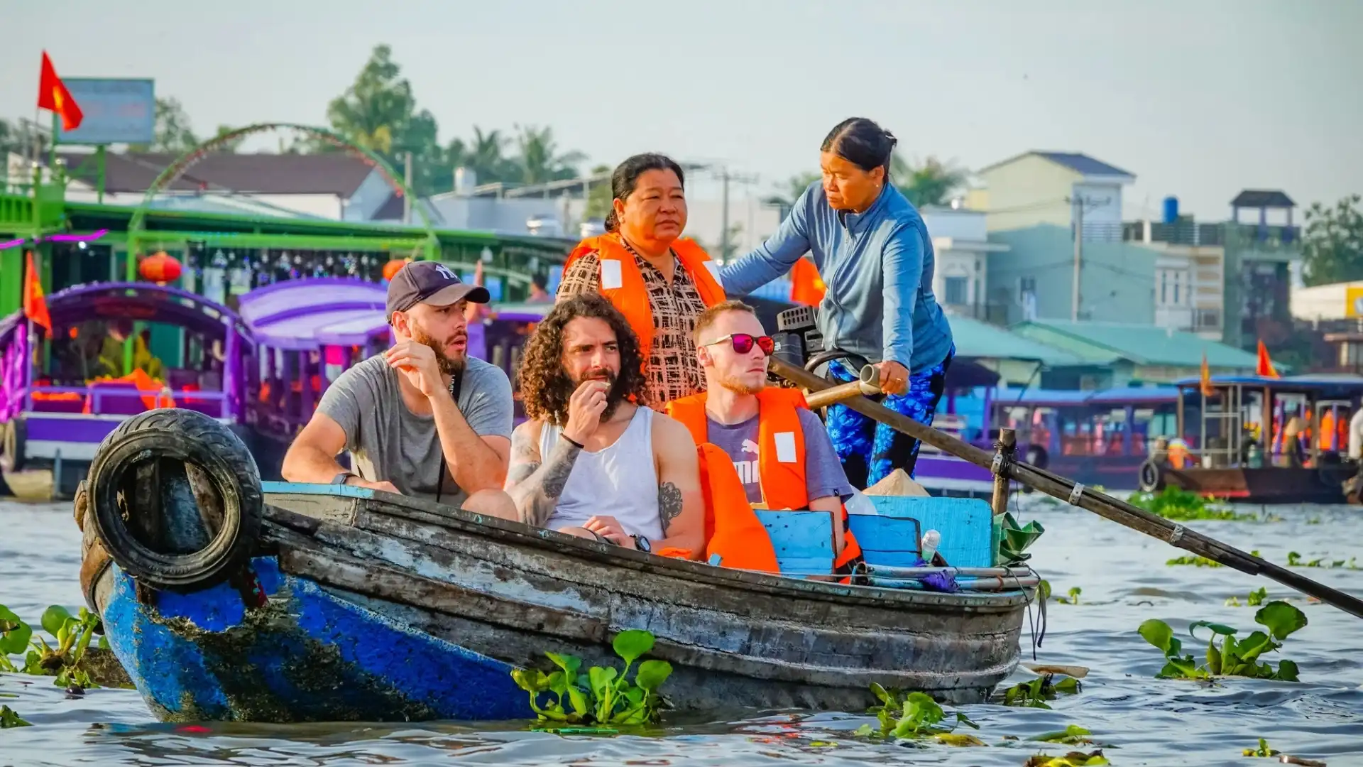 Mekong Smile Bassac Cruise Can Tho tourists enjoying local boat experience on Mekong River