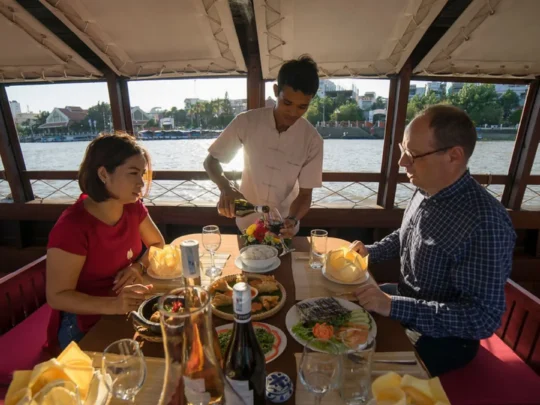 Dinner service on Bassac Cruise during sunset cruise in Can Tho
