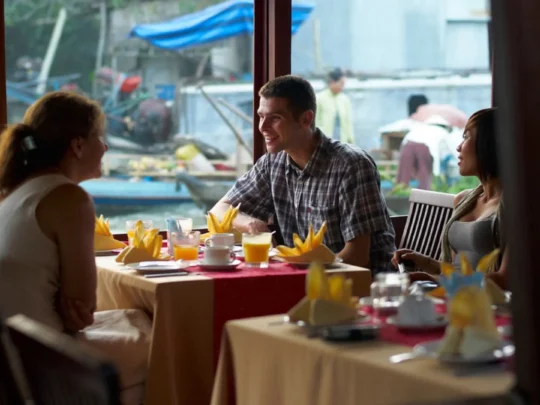 Family dinner on Bassac Cruise during an evening cruise on the Hau River, Can Tho