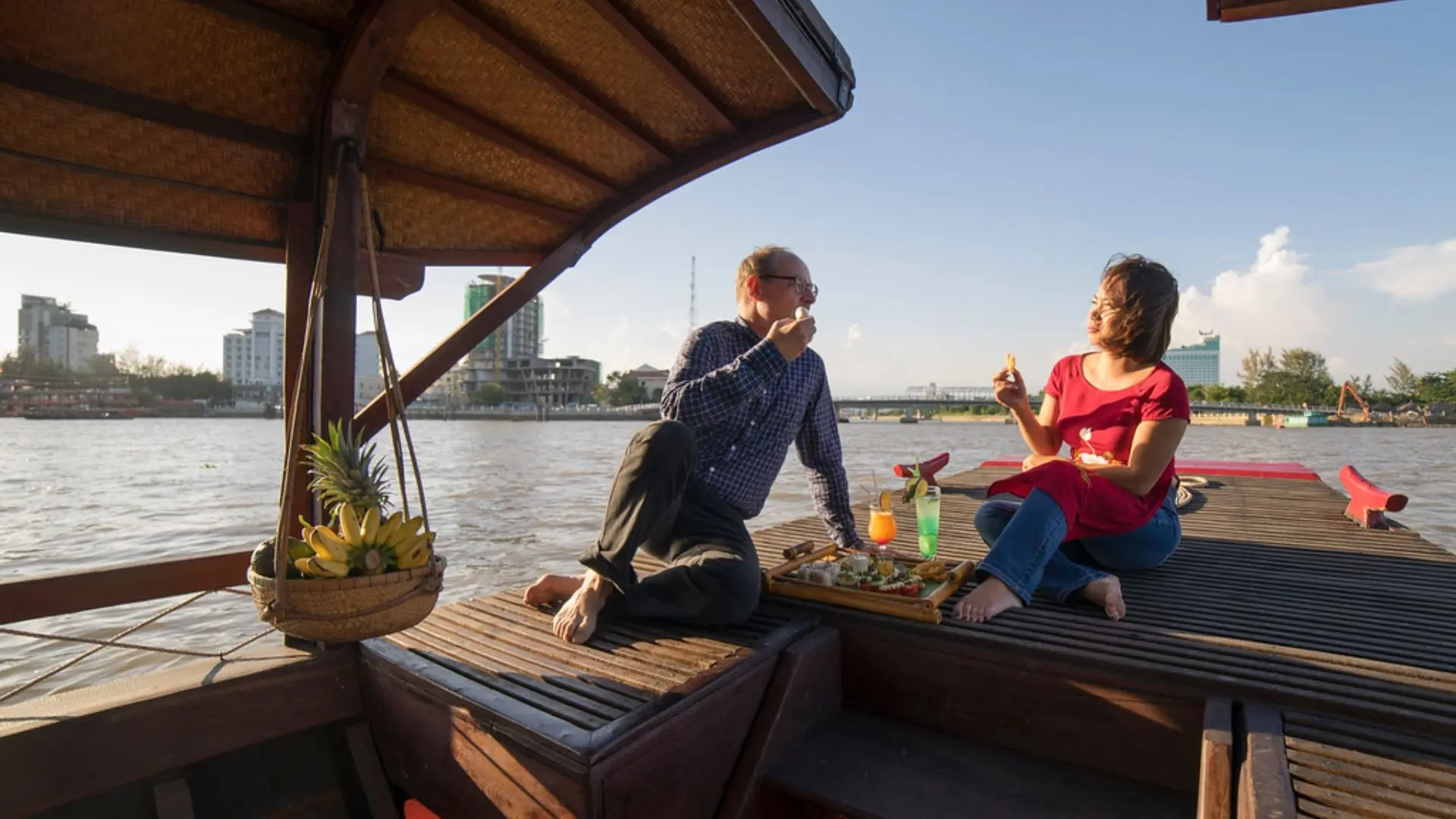 Guests relaxing on Bassac Cruise during sunset on the Hau River in Can Tho