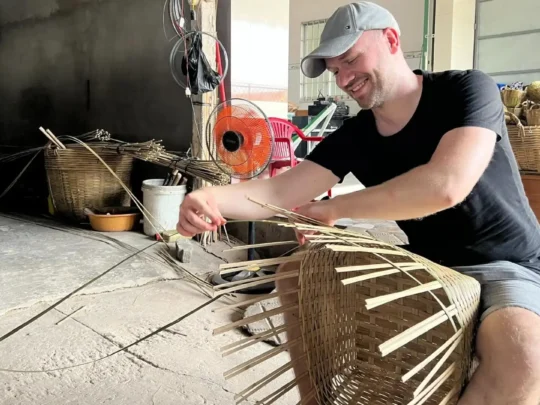 A traveler making a bamboo basket in Cai Be