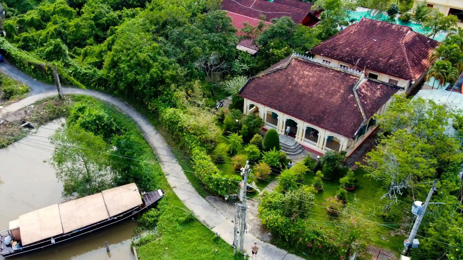 Aerial perspective of Ba Duc Ancient House nestled in a dense fruit orchard
