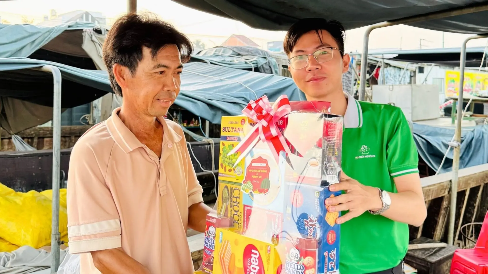 Local resident receiving Tet gifts from Mekong Smile at Cai Rang Floating Market, Can Tho